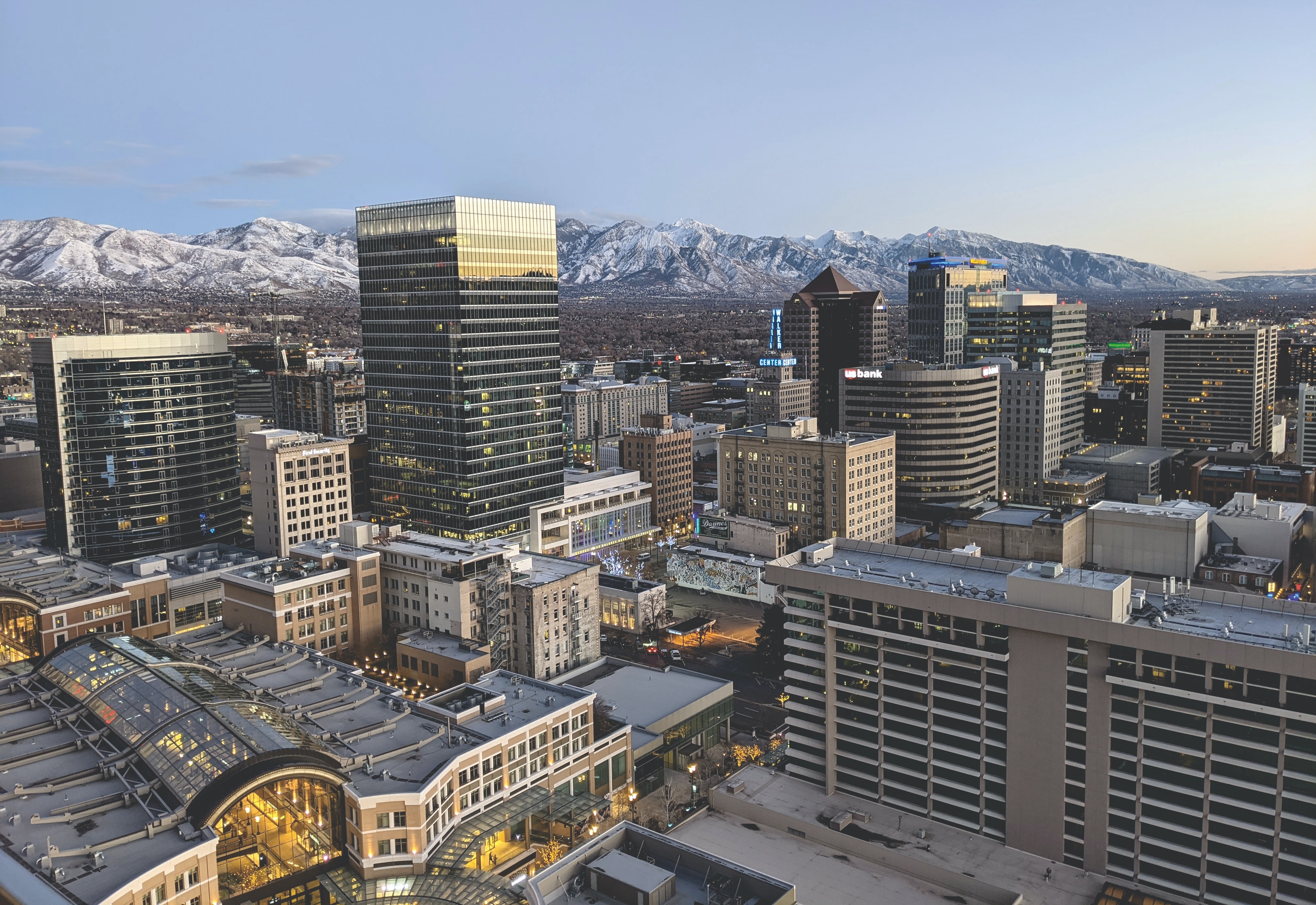A view of the Salt Lake City skyline in the foreground, with snowcapped mountains in the background