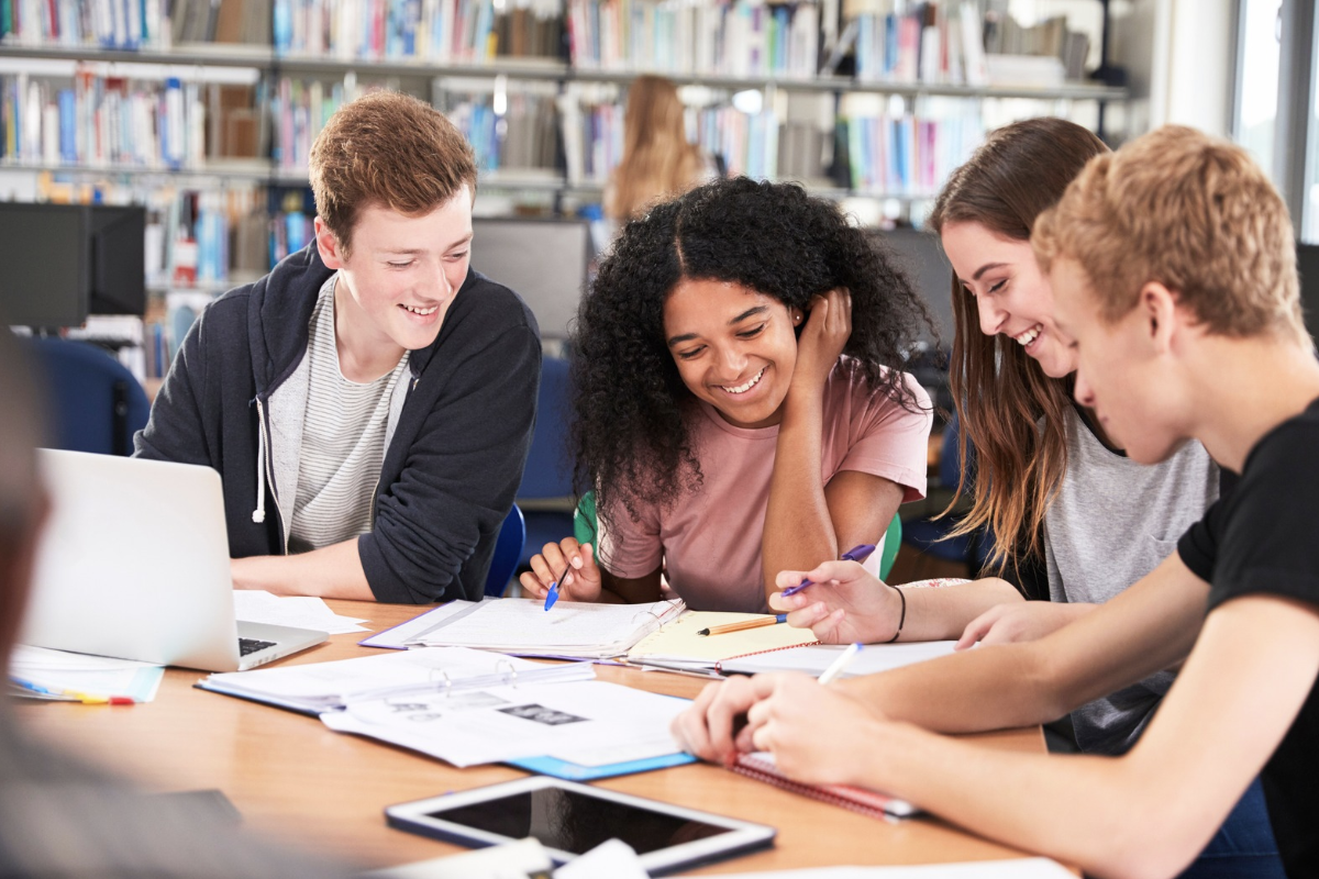 High school students studying at a table.