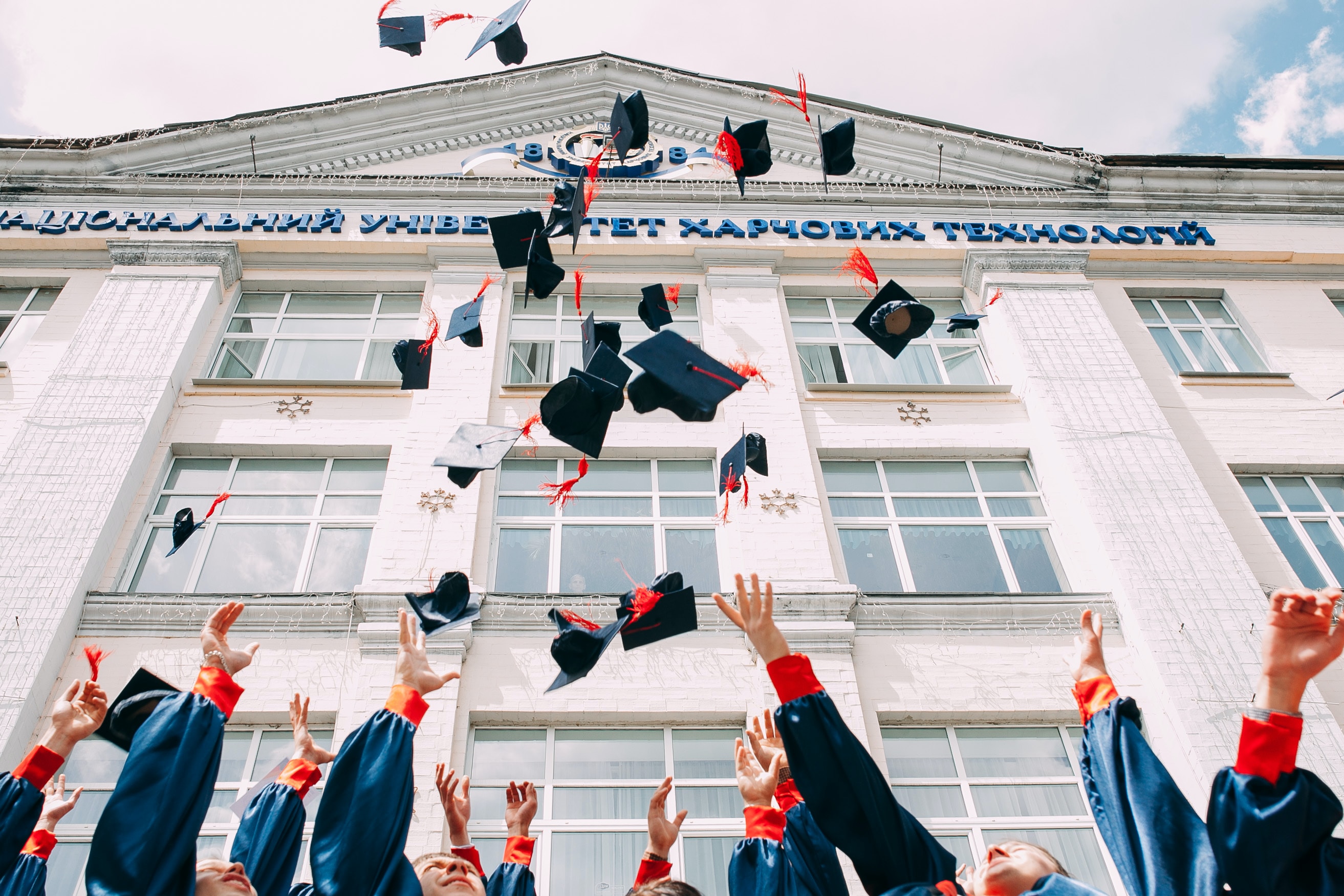 College graduates throwing their caps into the air